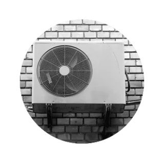 An outdoor condenser on a brick wall