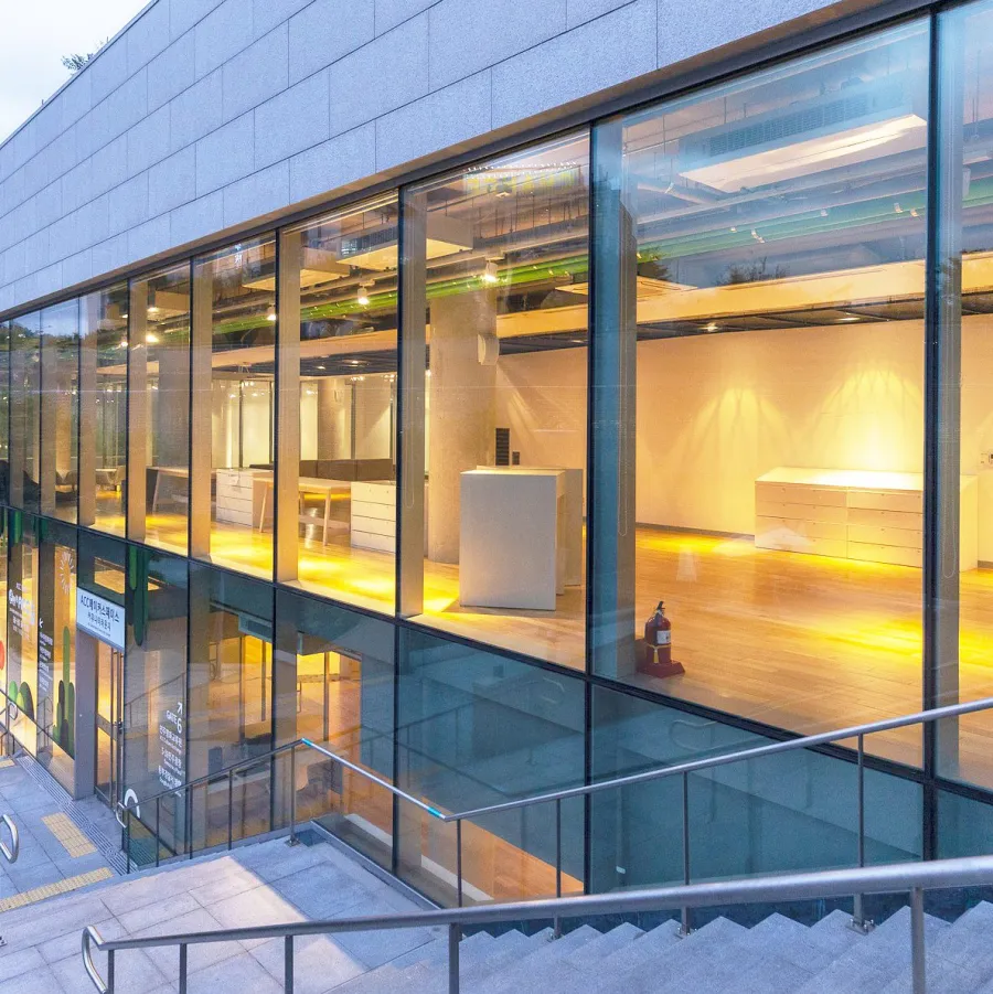 A glass-fronted office building lit from inside